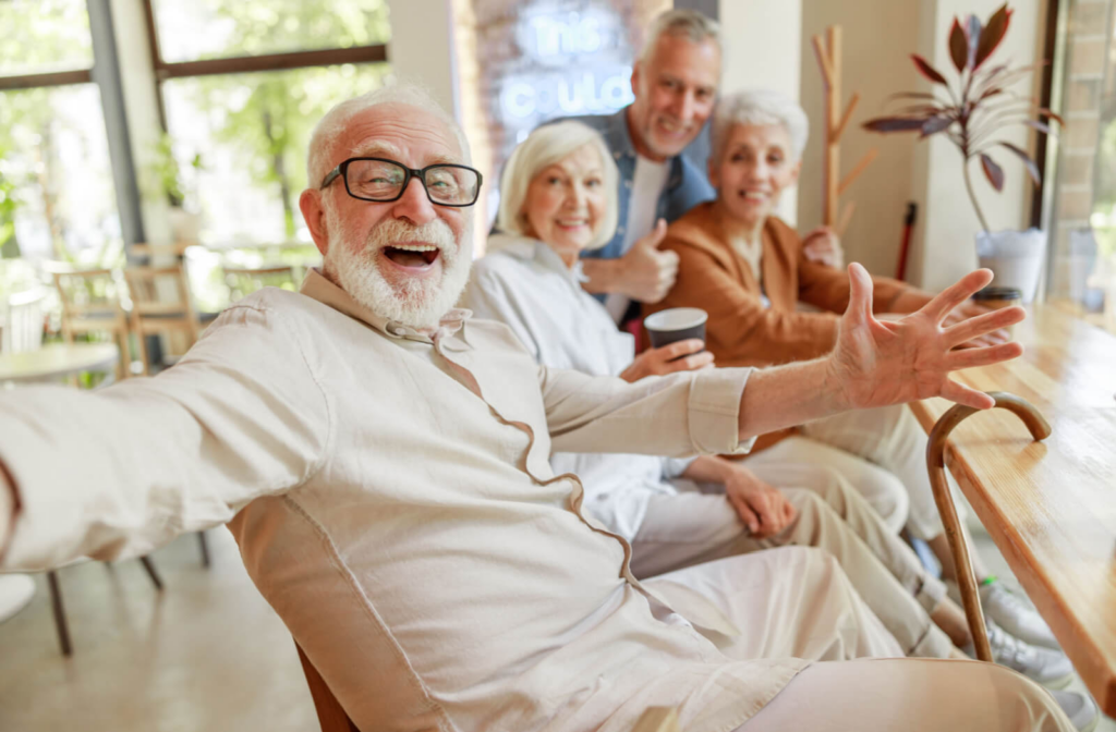 Four seniors sitting at a cafe counter grin while taking a selfie, enjoying their time together near their senior living home Also, I'm pretty sure this photo has been used in blogs previously. Maybe replace this image with a more unique photo?
