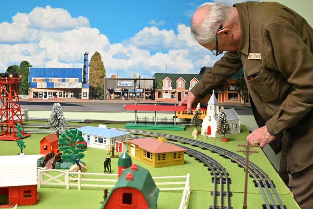 a senior interacts with a train set at a bethany village community