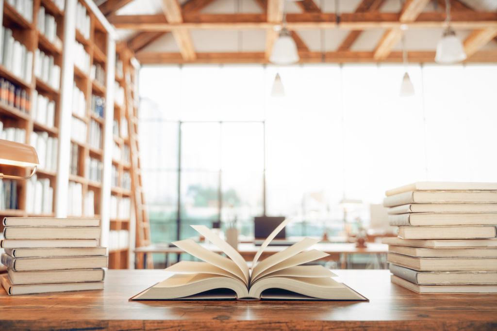 Open books in a light-filled library