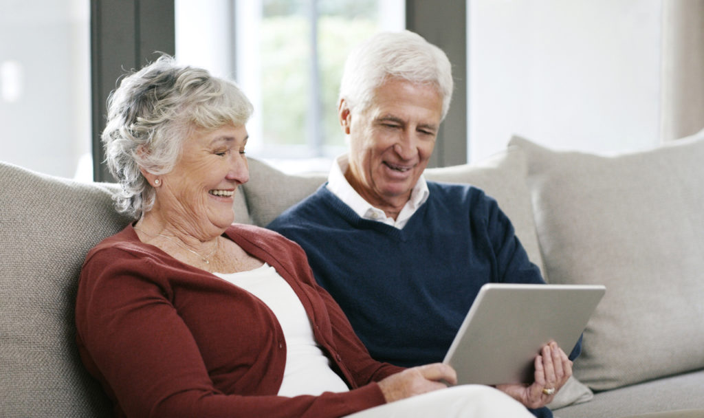 Shot of a senior couple using a digital tablet on the sofa at home