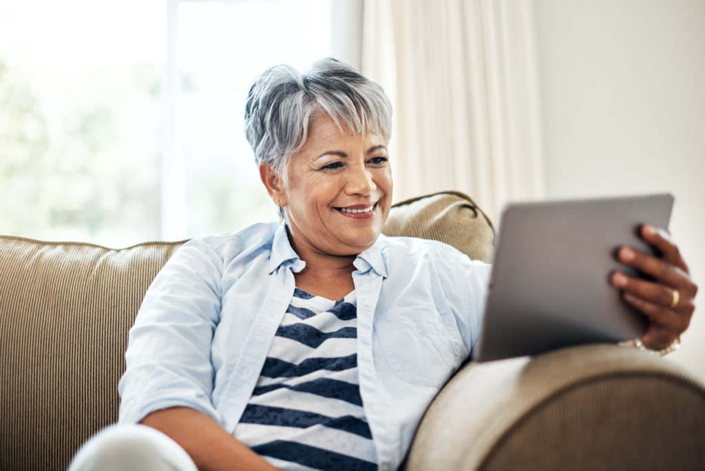 Senior woman using a tablet at home