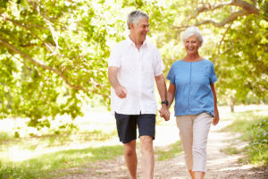 Shot of Senior couple walking on a path together in the countrysidea female physician working with a senior patient in a nursing home