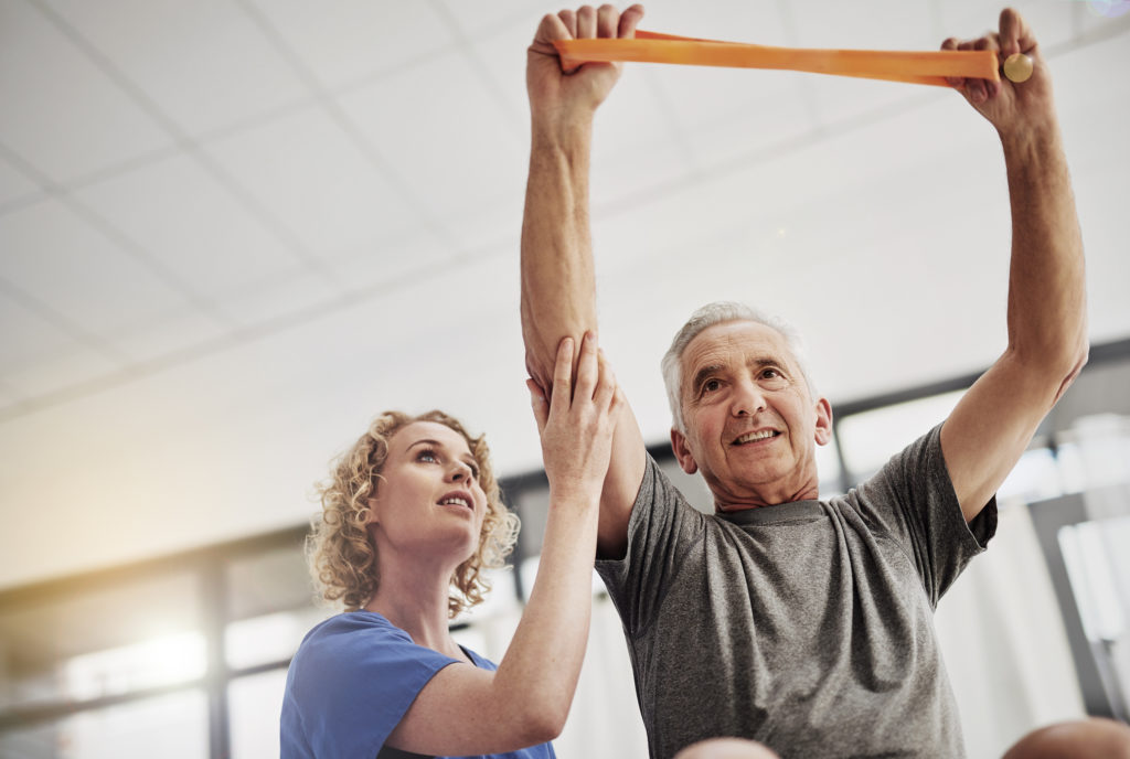 Shot of a female physician working with a senior patient in a nursing home