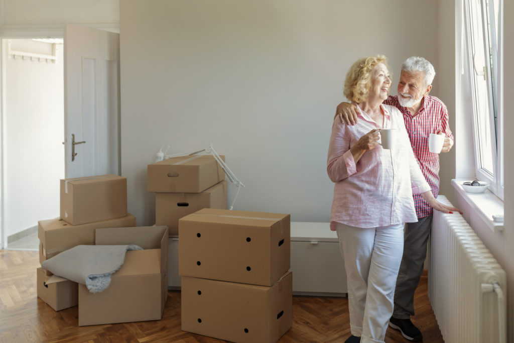 Senior Couple at Moving Day Looking Through the Window