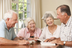 Two Senior Couples Attending Book Reading Group