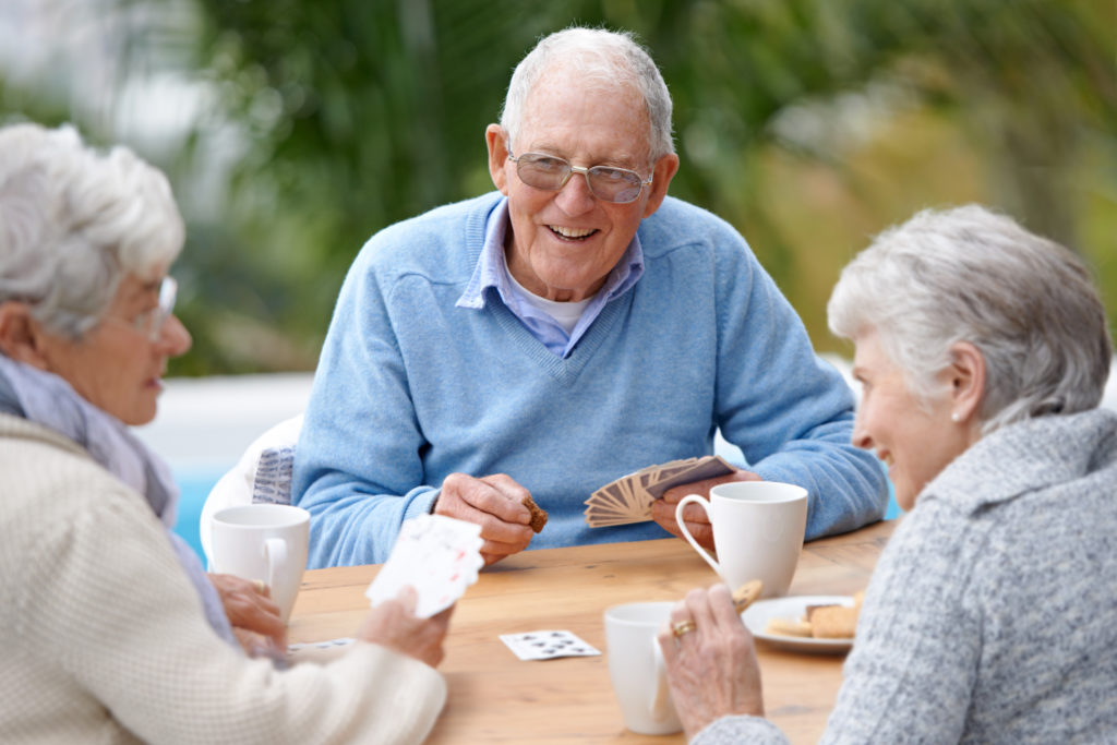 A group of senior citizens playing cards together