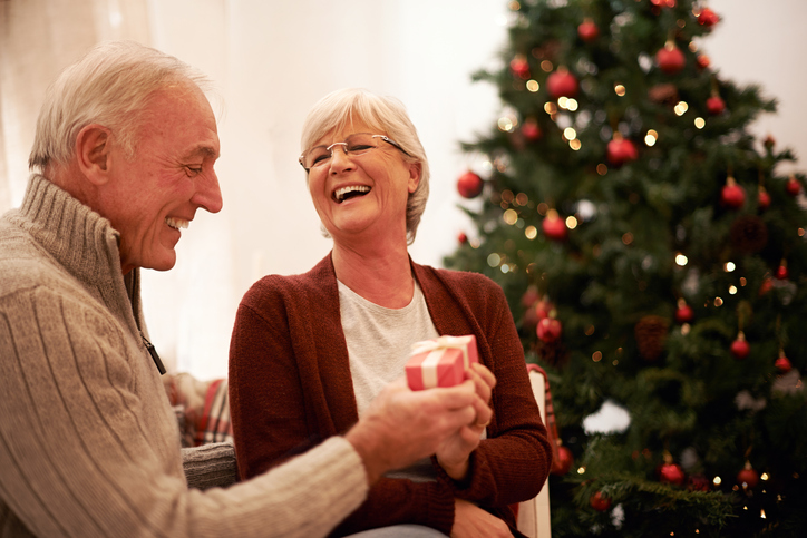 Shot of a loving senior couple exchanging gifts at Christmas