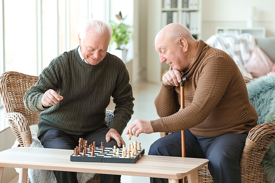 two mature men playing chess