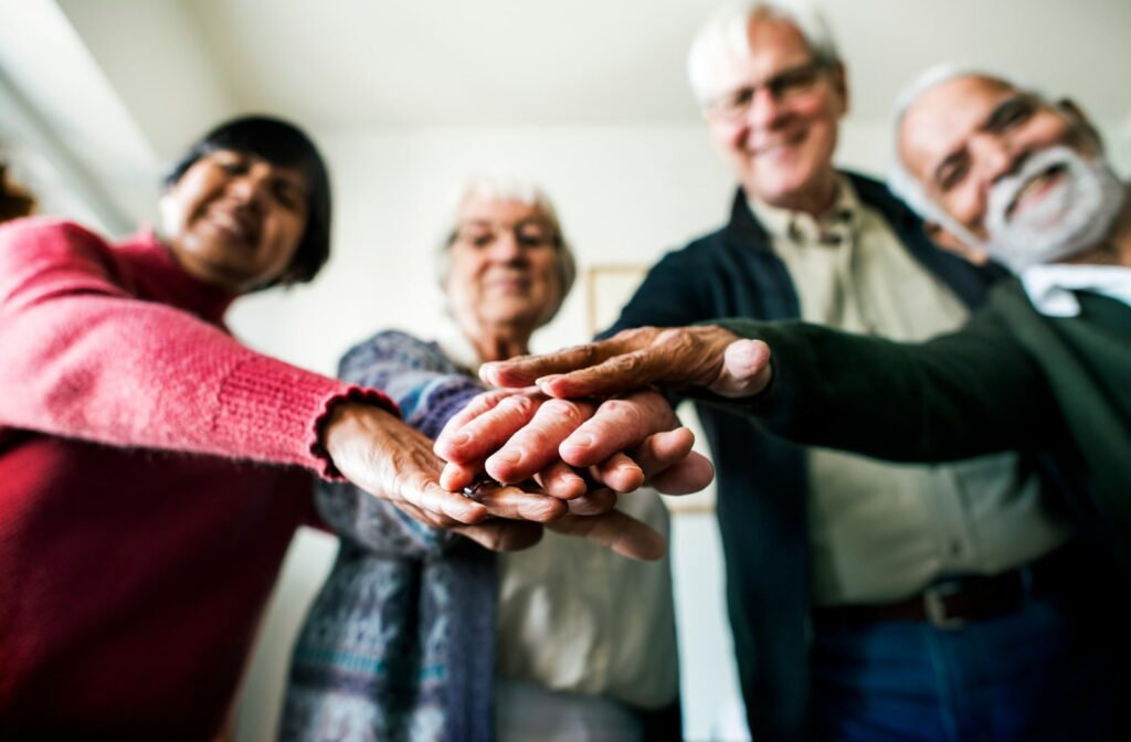 A group of seniors putting their hands together