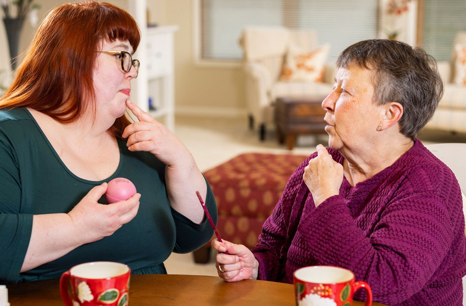 A speech-therapist working with an older adult as a part of their recovery.