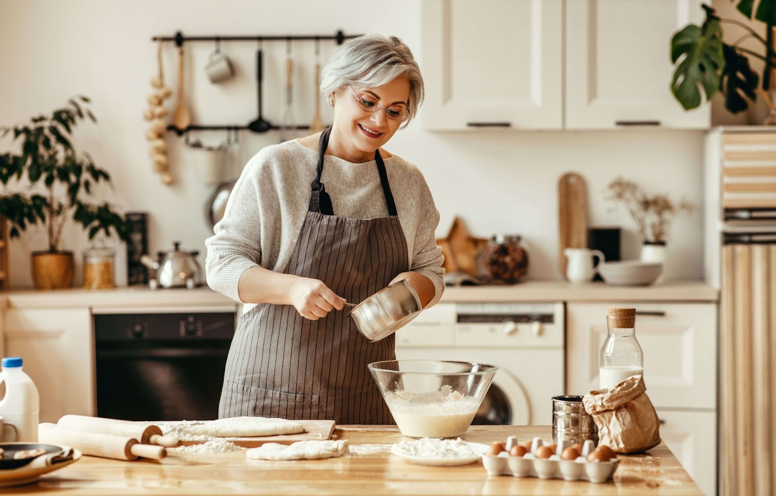 An older adult preparing a meal in their accessible kitchen.